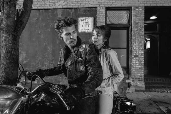 Benny (Austin Butler) and Kathy (Jodie Comer) get ready to ride away from the bar in The Bikeriders. 