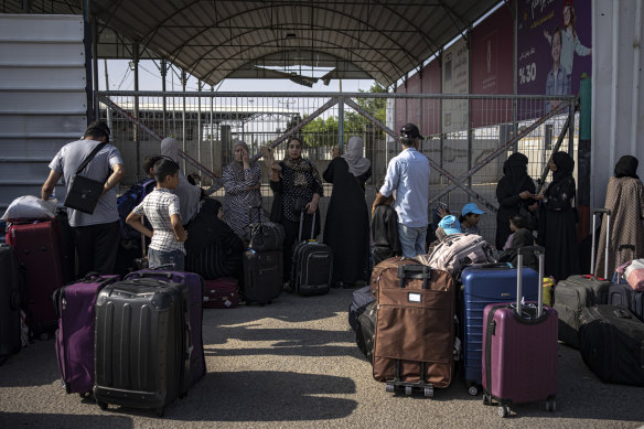 Palestinians wait to cross into Egypt at Rafah, Gaza Strip.