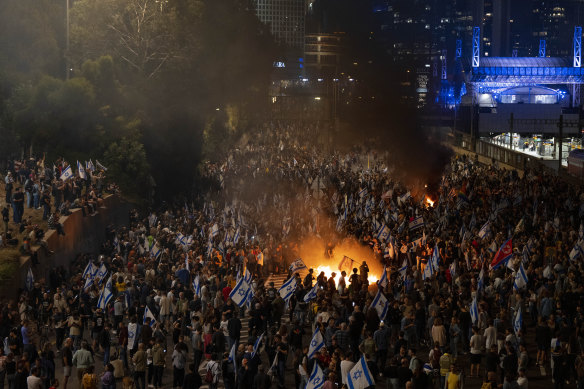 People protest the Israeli PM’s decision to sack his popular defence minister in Tel Aviv.