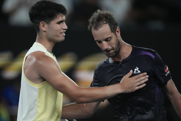 Carlos Alcaraz is congratulated by Richard Gasquet following their first-round match at the Australian Open.