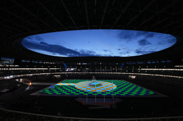 The evening sky illuminates the field in the Olympic Stadium prior to the start of the closing ceremony .