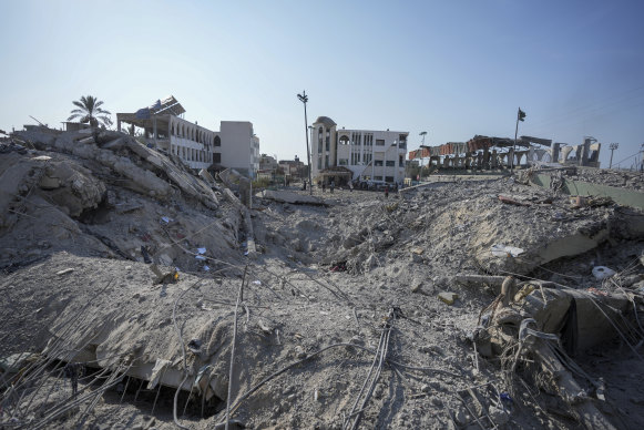 Palestinians inspect the rubble of a school destroyed in an Israeli airstrike on Deir al-Balah, central Gaza Strip.