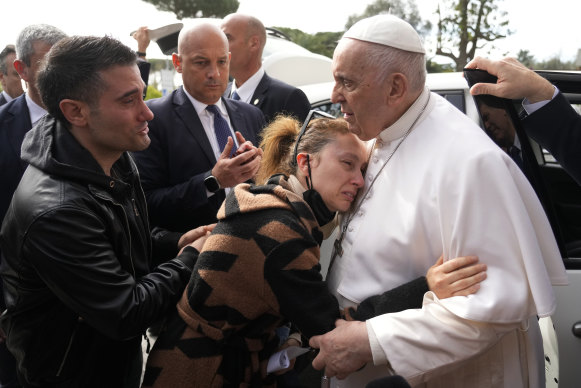 Pope Francis consoles Serena Subania and Matteo Rugghia, left, who lost their 5-year-old daughter Angelica.