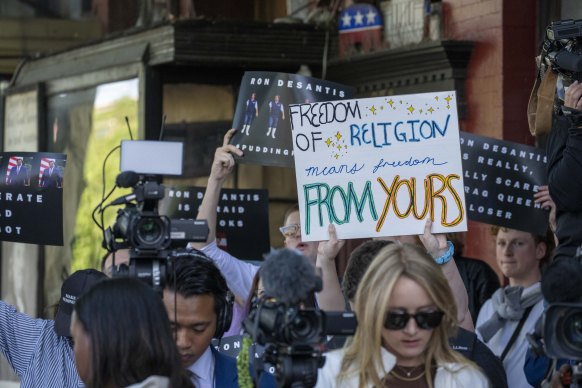 Activists protest outside an event attended by Florida Governor Ron DeSantis in Washington on Tuesday.