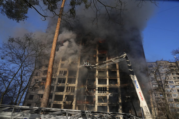 Firefighters work in an apartment building damaged by shelling in Kyiv, Ukraine, on Tuesday. More apartment buildings have been hit on Wednesday.