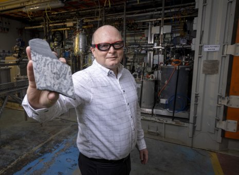 Jared Osborne, general manager of Rio Tinto’s laboratory in Melbourne that worked out how to process Jaradite, holds a lump of the rare mineral.  