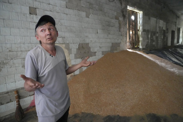 Farmer Serhiy stands near a mound of grain in his barn in the village of Ptyche in eastern Donetsk region, Ukraine. An estimated 22 million tonnes of grain are blocked in Ukraine and pressure is building as the new harvest begins.