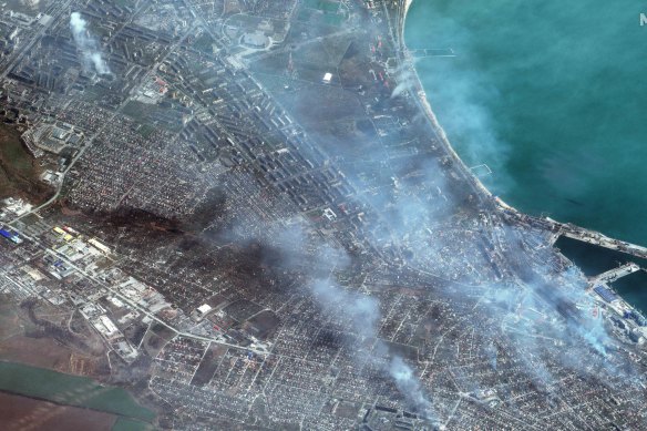 This satellite image provided by Maxar Technologies shows a view of port facilities and buildings on fire in western Mariupol, Ukraine.