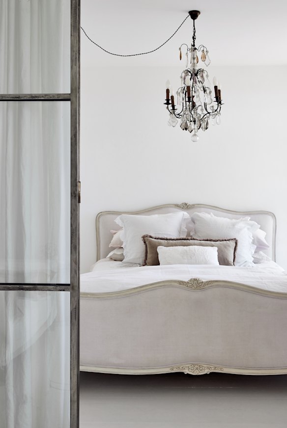 Steel-framed glass doors replaced a wall between the sitting room and bedroom. 