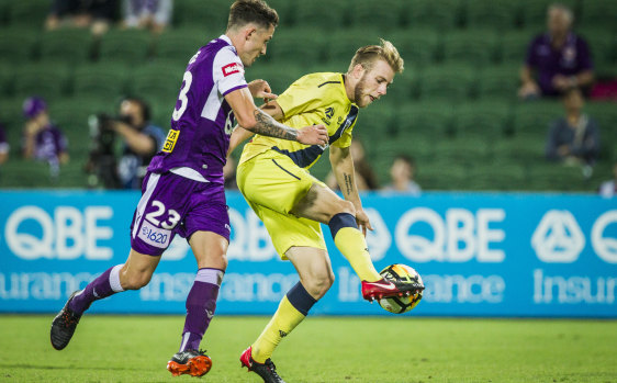 Scott Neville of the Perth Glory and Andrew Hoole of the Central Coast Mariners fight it out.