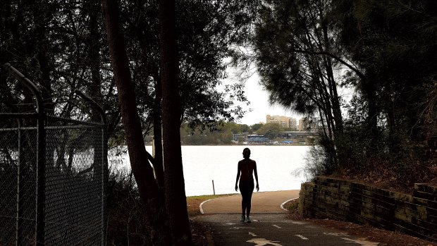 A woman walks along a path near Leichhardt Oval on the Bay Run in Lilyfield where a man has been indecently assaulting women.
