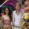 Prince Harry and Meghan pose for photos with traditional Carnival dancers during a welcoming ceremony, at the Delia Zapata National Arts Center, in Bogota, Colombia, Thursday, Aug. 15, 2024. (AP Photo/Ivan Valencia)