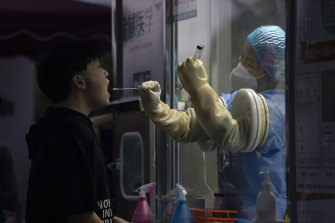 A man gets swapped during a nuclei test for COVID-19 in Beijing.