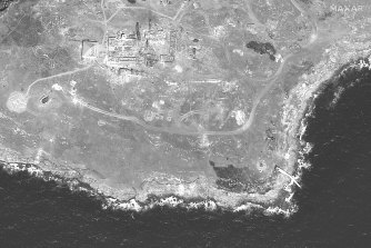 This WorldView-1 satellite black and white image shows the southern end of Snake Island with a ruined tower and burned vegetation in several locations.