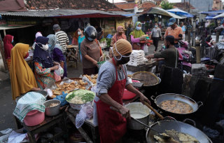 Shoppers at a fried food stall at Karangayu Market in Semarang, Central Java.