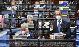 Prime Minister Muhyiddin Yassin speaks at a special session of parliament, which resumed this week for the first time since a state of emergency was declared in January.