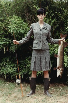Model, Stella Tennant, wearing a grey tweed wool jacket and matching knee-length pleated skirt, by Anna Su.