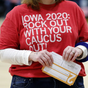 A local resident holds a presidential preference card during a Democratic Party caucus in Iowa.