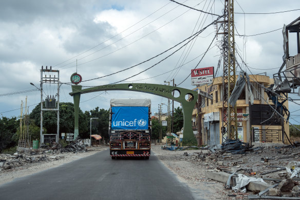 A UN truck passes buildings destroyed by Israeli airstrikes on Thursday in Kafra, Lebanon.