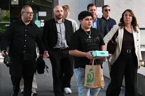 Family, (left to right) Simon Tadros, Phil Hughes, Nicholas Tadros (middle) and Jane Manns, (right) with others leave the Coroners Court inquest into the 2023 Sea World helicopter collision deaths, at the Brisbane Magistrate’s Court on Friday.