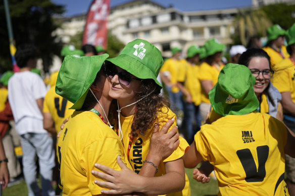 WYD 2023 volunteers from around the world greet each other during a Mass in Estoril, outside Lisbon on July 26.