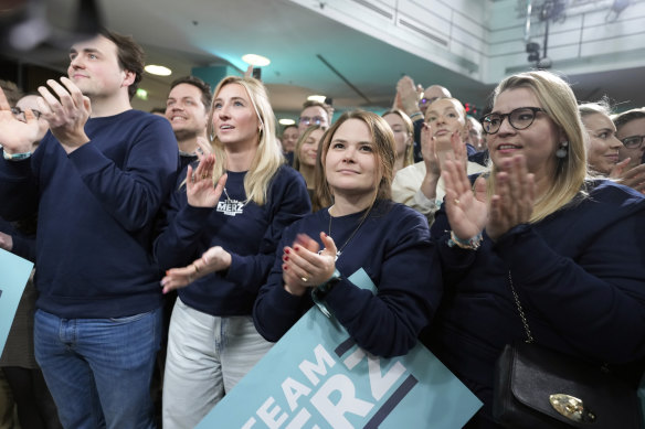 Supporters of Friedrich Merz, leader of the opposition conservative Christian Democratic Union party, wait for the election results.