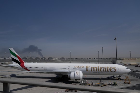Dubai International Airport, with smoke from an airstrike in the distance. The airport has been closed since Sunday.