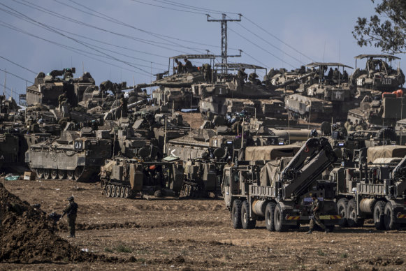 Israeli soldiers gather in a staging area near the border with Gaza Strip, in southern Israel.