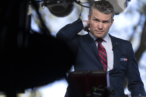 Defence Secretary Pete Hegseth preparing to give a TV interview outside the White House last week.