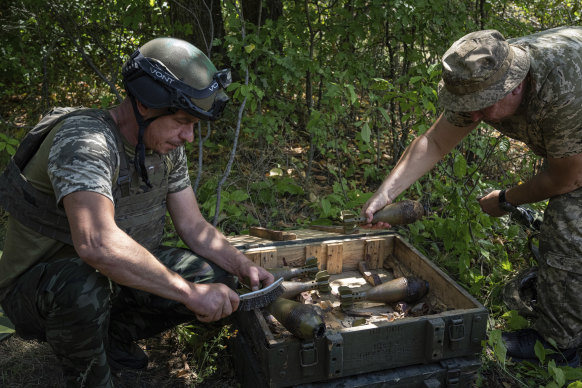 Ukrainian soldiers clean mortar shells during training in the Kharkiv region.