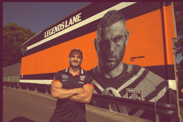 Robbie Farah and the mural dedicated to him at the Sackville Hotel in Rozelle.