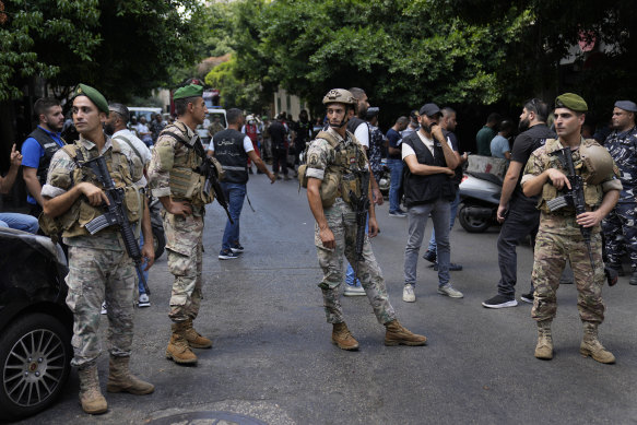 Lebanese soldiers stand guard outside a bank while Bassam al-Sheikh Hussein took hostages.