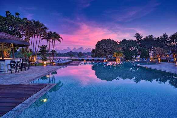 Pinks skies while poolside at Azerai Le Resident Hue.