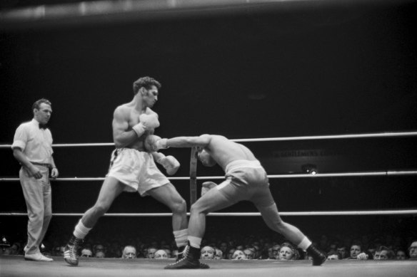 "Filipino Rapalo catches Australian middleweight champion Tony Mundine with a straight left (top) before Mundine set himself (above) for a right rip to the body, the punch which left Rapalo rolling on the floor 2.20 secs into the second round." June 9, 1970.