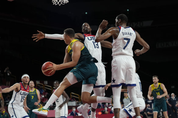 Dante Exum drives and looks to pass.