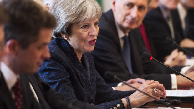 Prime Minister Theresa May, centre, avoided blaming Russia, for now.