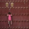 A young girl climbs to look through a gap of the closed doors of the Hall of Prayer for Good Harvests at the Temple of Heaven on May 12, 2026 in Beijing, China. In a rare occurrence, the popular historic site has been closed for the next three days in preparation for a tour by U.S. President Donald Trump and Chinese President Xi Jinping on Thursday.