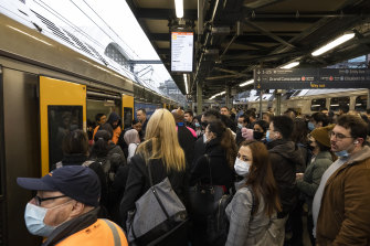 Commuters clamour onto packed trains at Central Station on Wednesday.