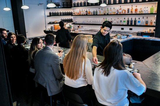 Chef Yu Orita passing one of eight rounds of sushi to Nidaime’s diners.