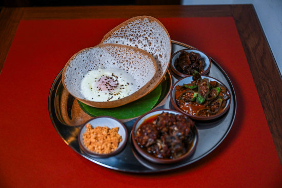 The hopper set includes rice flour pancakes, two curries and sambols.