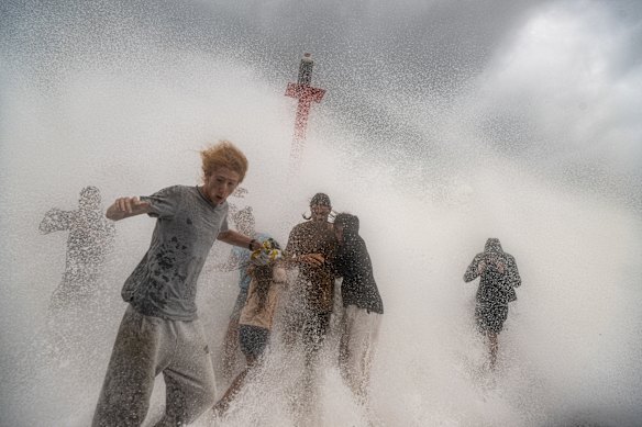Spectators battered by waves at Brunswick Heads in March.