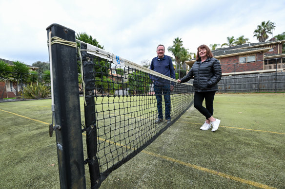 Ian and Lisa Waters at their communal tennis court in Doncaster East.