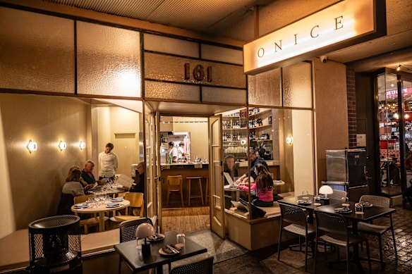 Onice has glowing glass wall lamps, sand-toned walls and padded banquette seating.