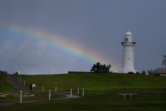 A rainbow appears over Macquarie Lighthouse, in Watsons Bay.  