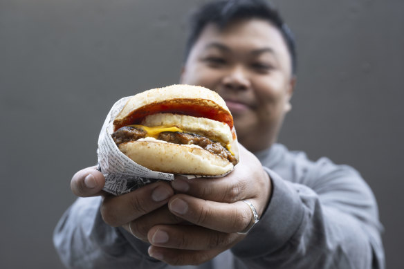 Tita’s co-owner Kenneth Rodriguez and his breakfast sandwich.