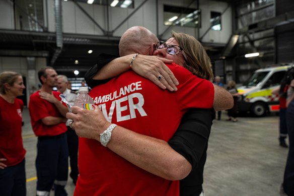 NSW Health Secretary Susan Pearce hugs a paramedic at Randwick Ambulance station after the announcement of a deal to end the long-running pay dispute.
