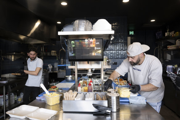 Pauly Davelis (right) at his Wetherill Park deli.