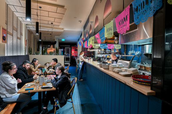 An open kitchen and bar dominate much of the space.