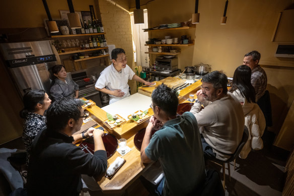 Head chef Yusuke Morita at work preparing sushi with his wife Izumi. 