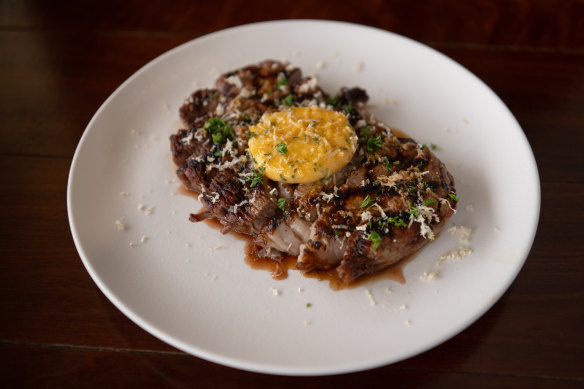 The scotch fillet is nicely scorched under melting puddles of garlic and herb butter.